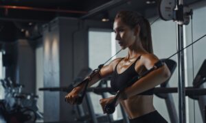 Sporty,Woman,Exercising,On,Multistation,At,Gym,For,Arm,And