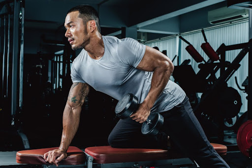 Man lifting dumbells at the gym