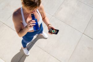 Woman,Tracking,Her,Fitness,Activity,Data,On,Mobile,Phone