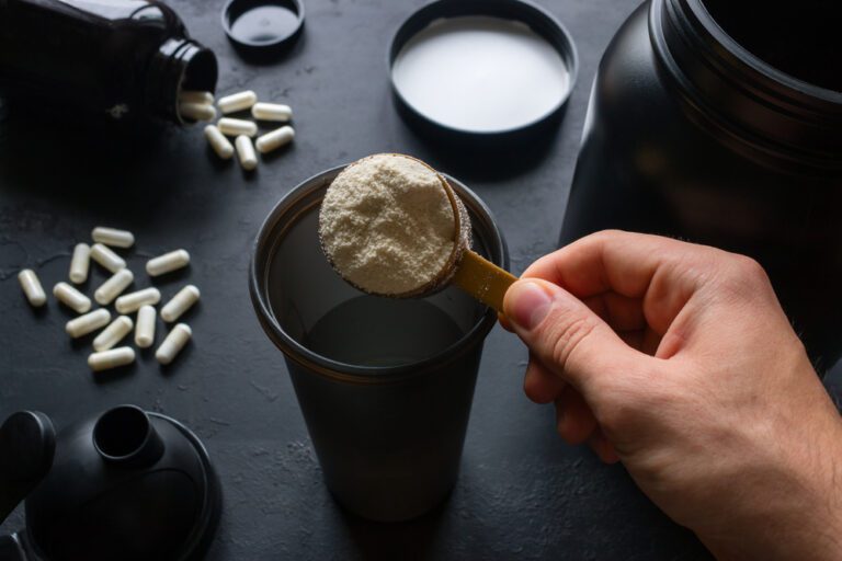 A scoop of protein powder and other supplements.