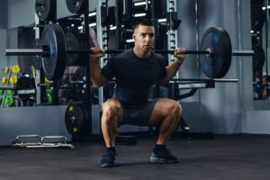 Man doing a squat variation in his workout.